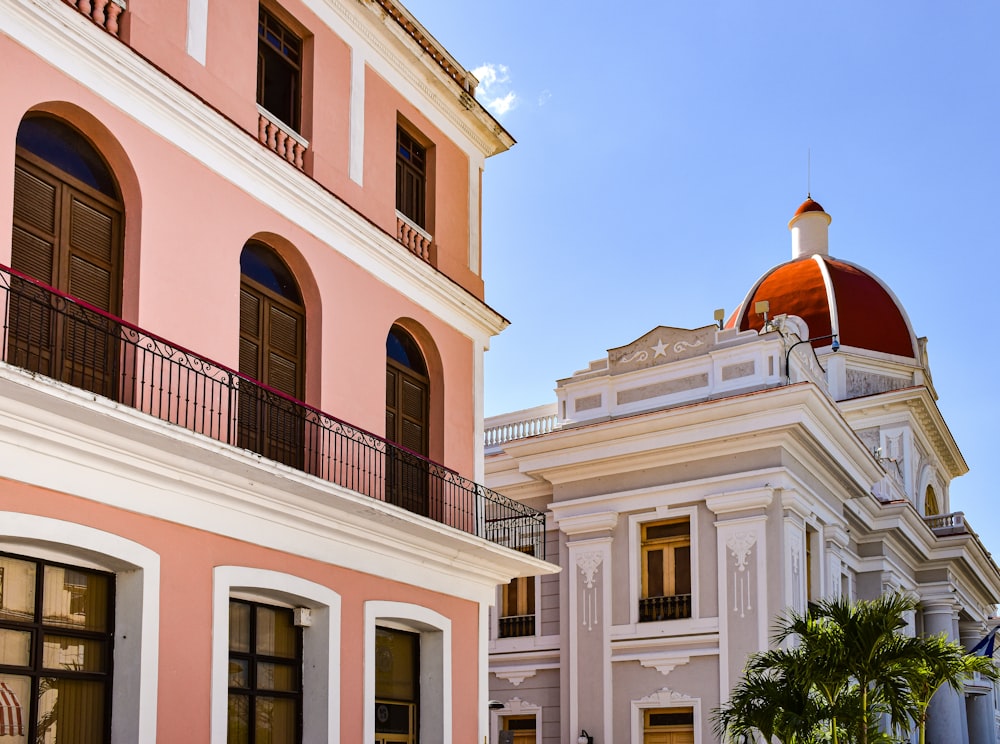 a pink and white building with a dome on top