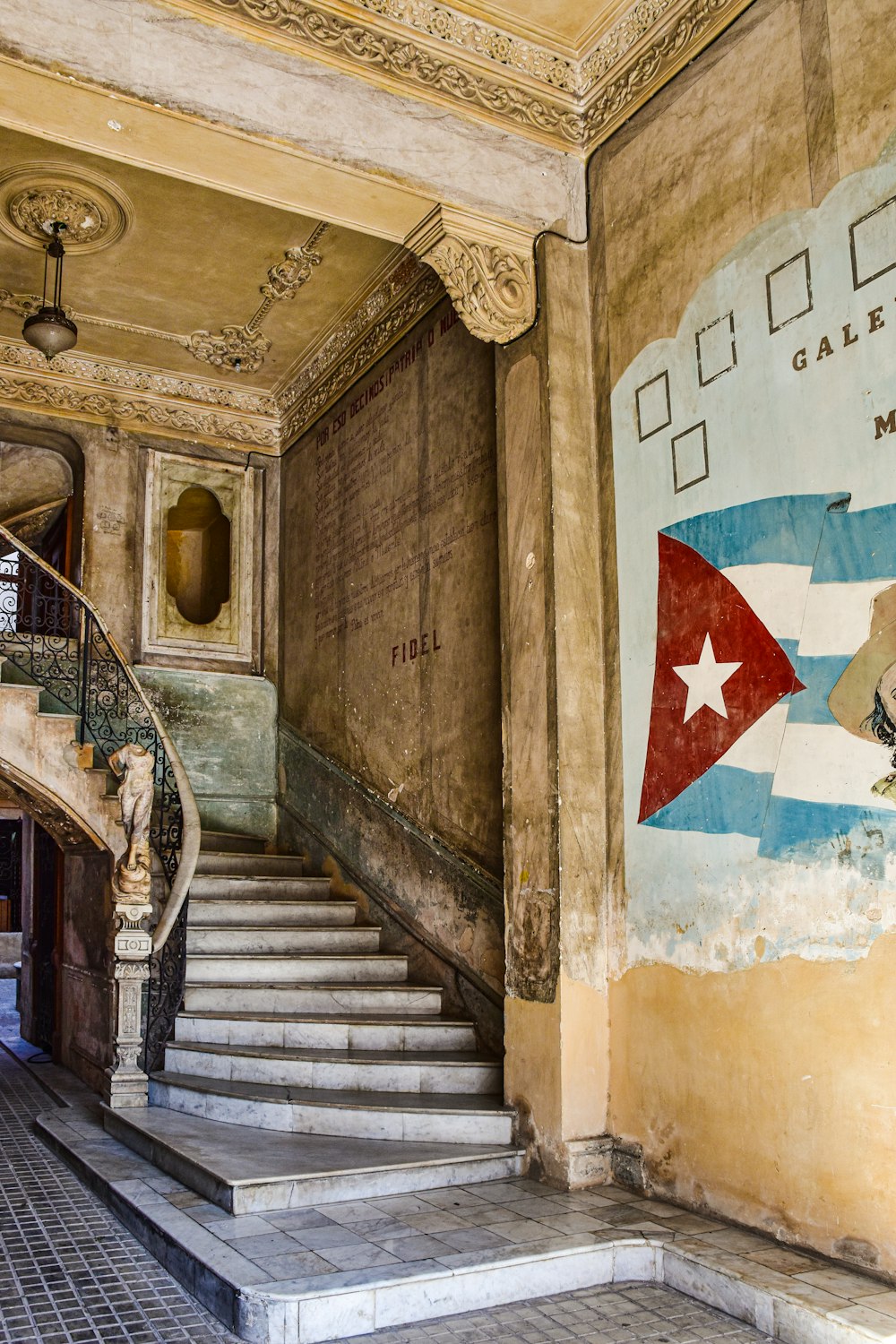 a staircase in a building with a flag painted on the wall