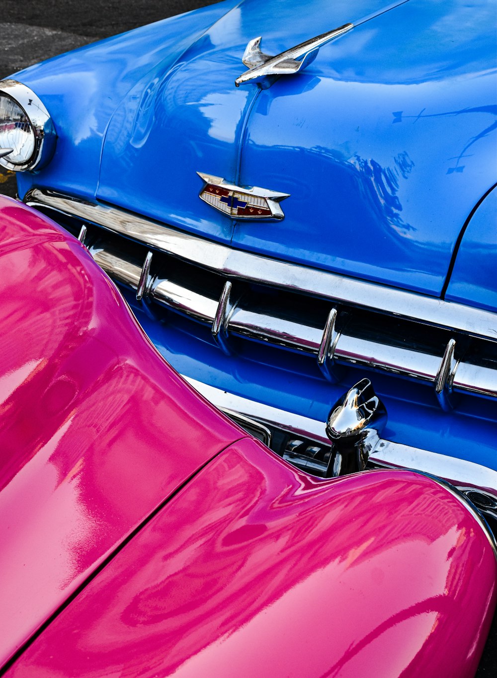 a close up of a pink and blue car