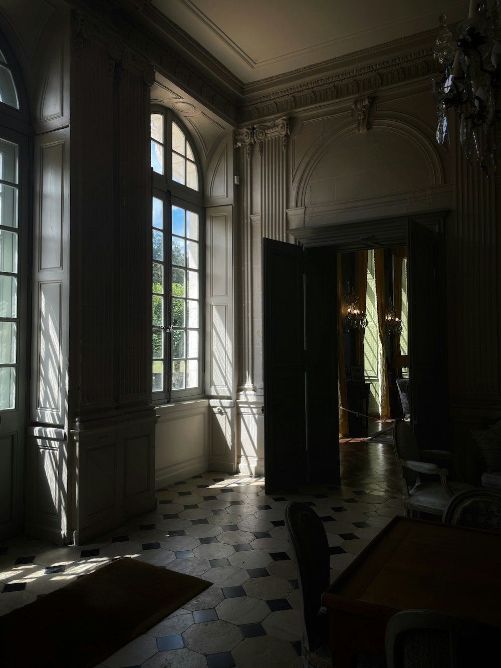 a room with a checkered floor and a chandelier