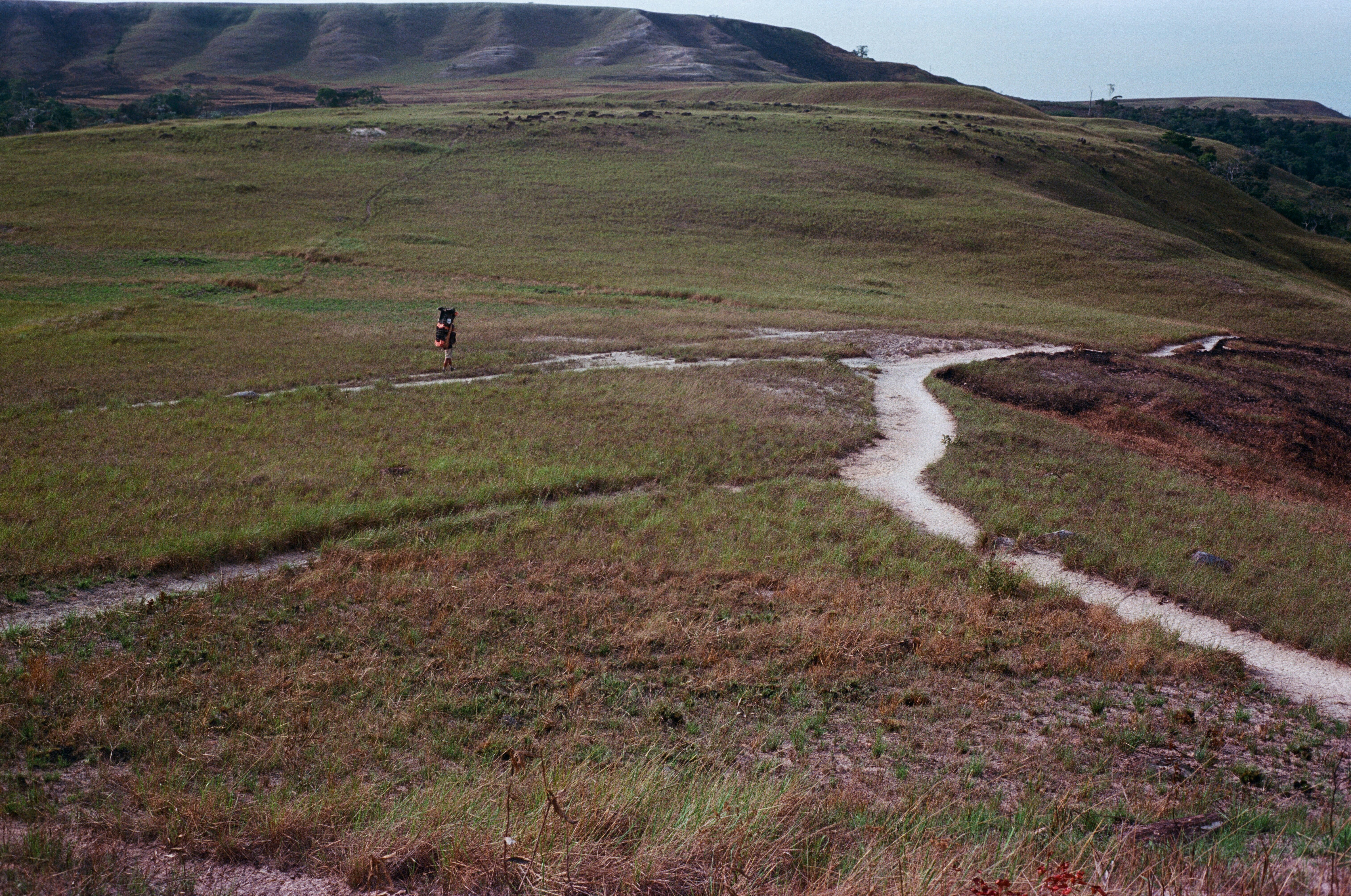 a person riding a bike down a dirt road