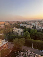 Aerial view of a lush green residential plot in Sarangapur at sunset.