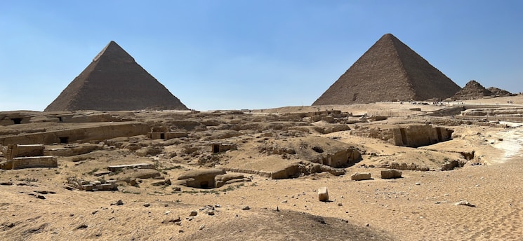 A stunning view of the Great Pyramids of Giza under a clear blue sky.