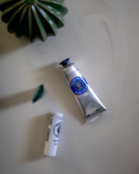 a tube of toothpaste next to a tube of toothpaste