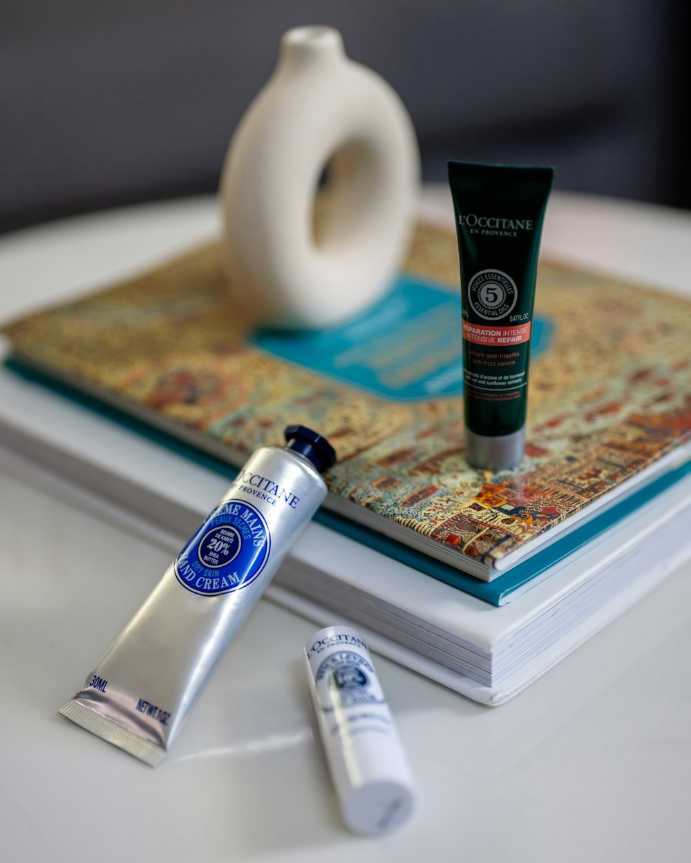 a table topped with a book and a tube of toothpaste