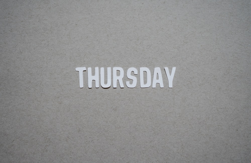 the word thursday cut out of paper