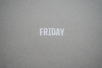 a close up of the word friday written on a piece of paper