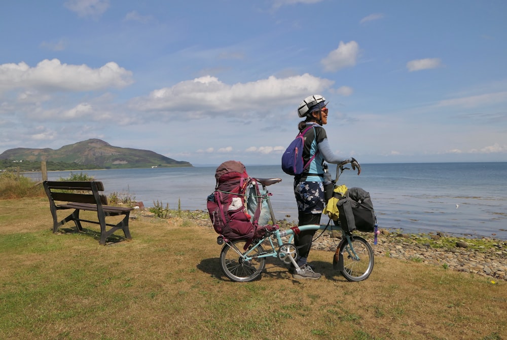 a couple of people that are standing next to a bike