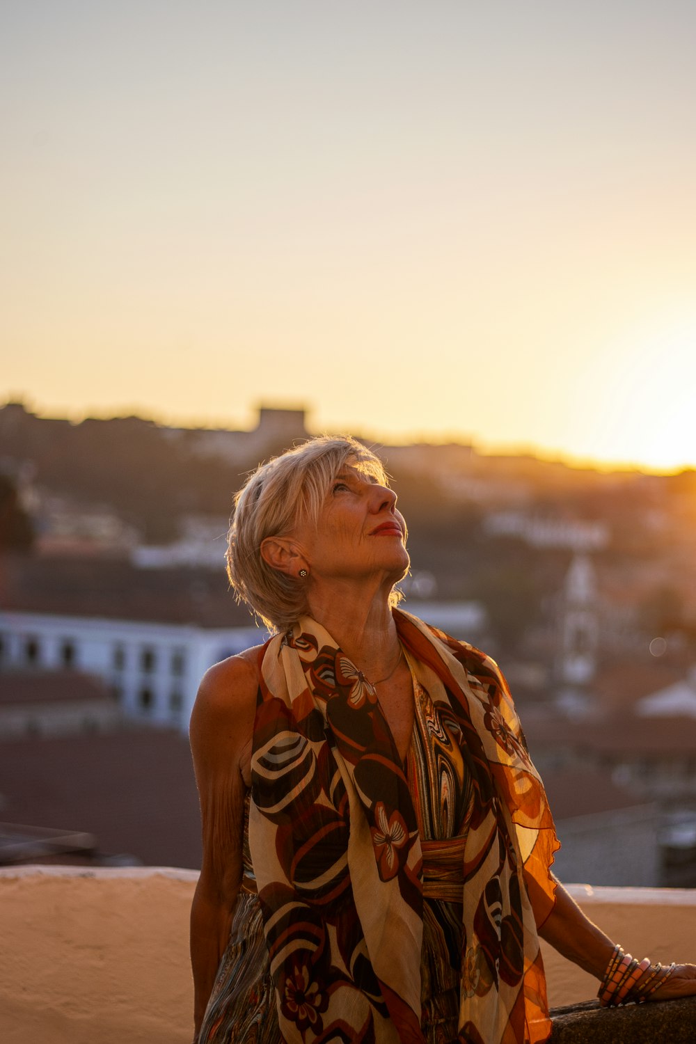 a woman standing on top of a sandy beach