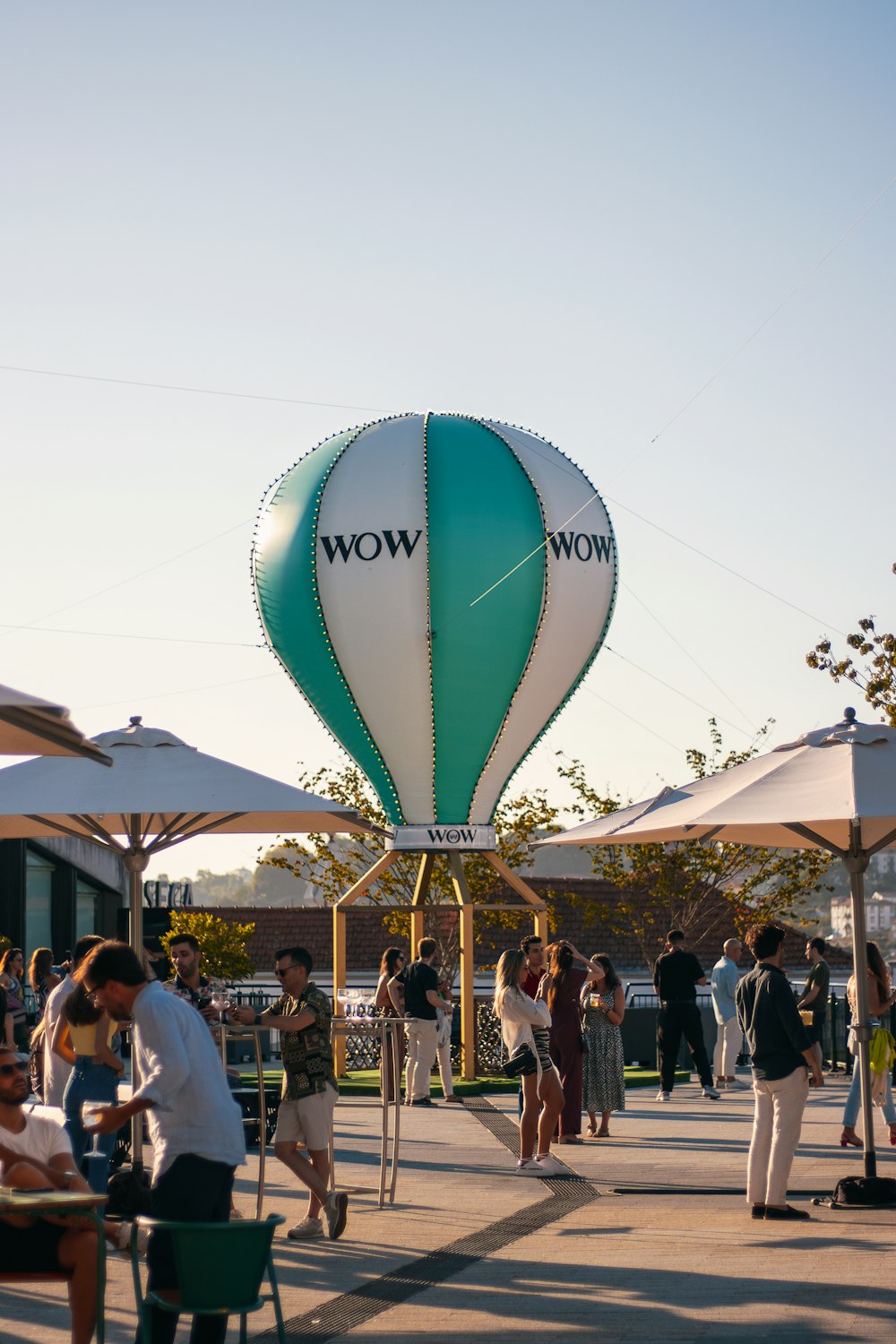 a group of people standing around a hot air balloon