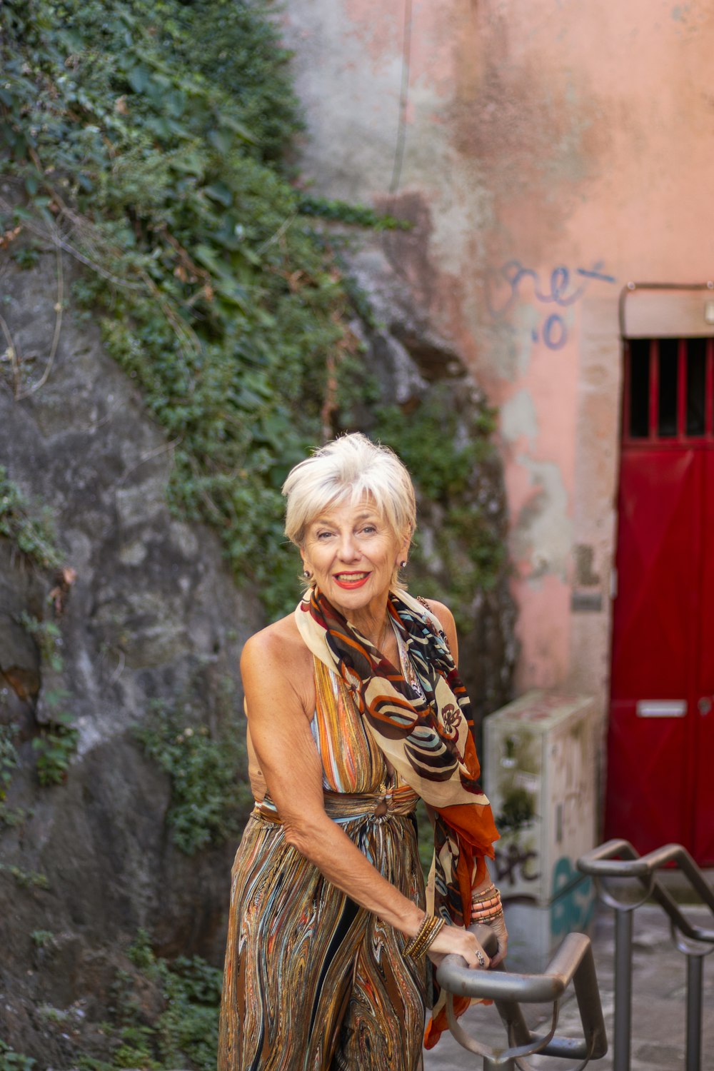 a woman in a long dress is holding a metal object