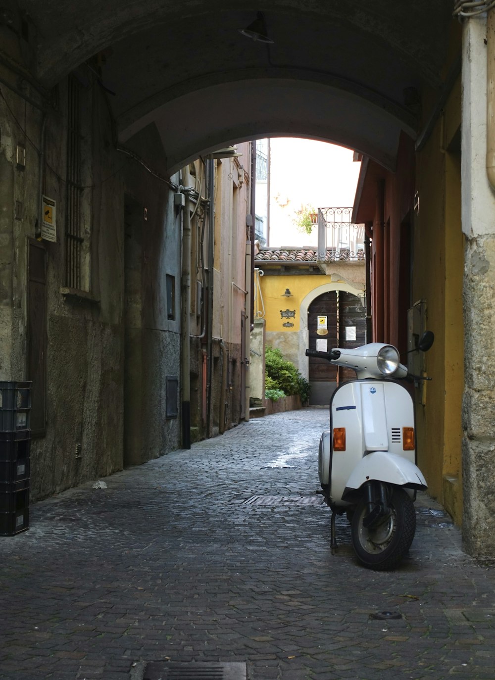 a motor scooter is parked in an alley way