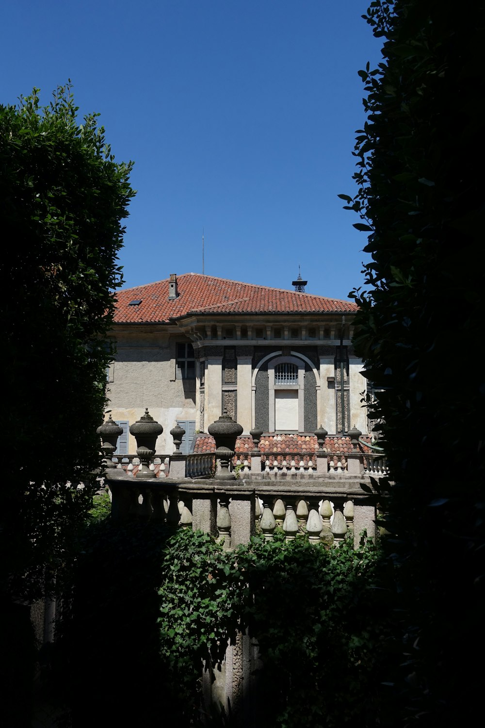 a building with a red roof and a balcony