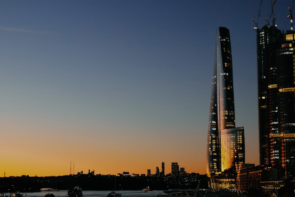 a very tall building sitting next to a body of water