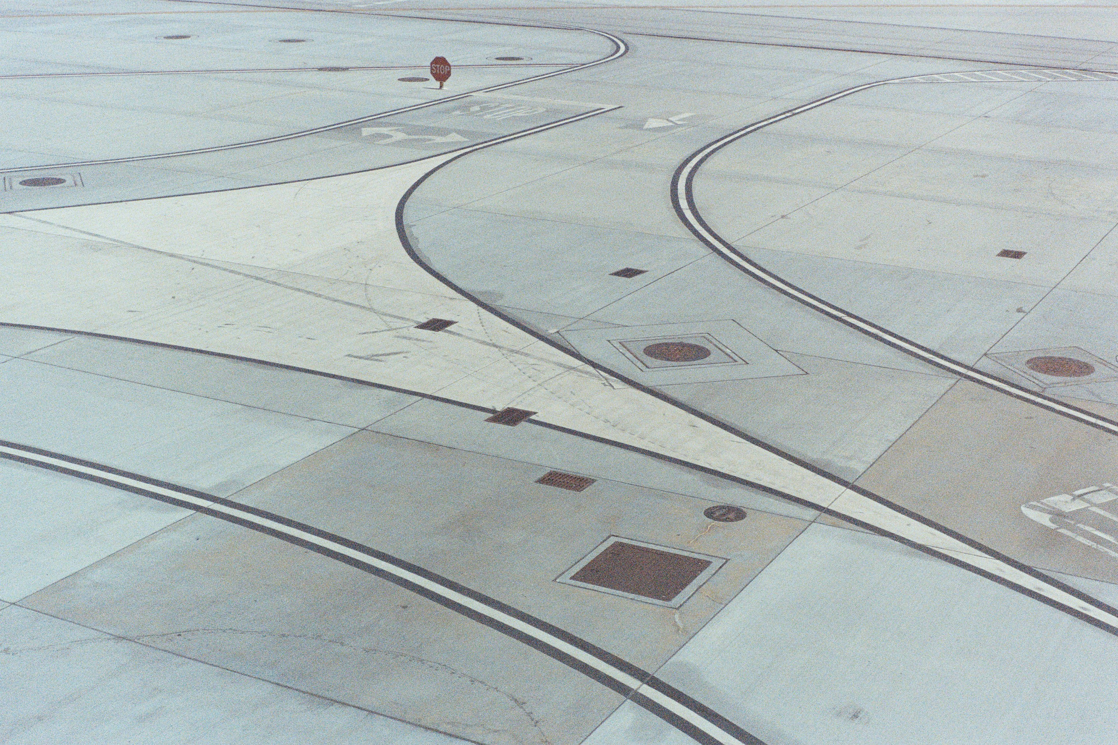 an aerial view of an airport runway with a person standing on the runway, Airport