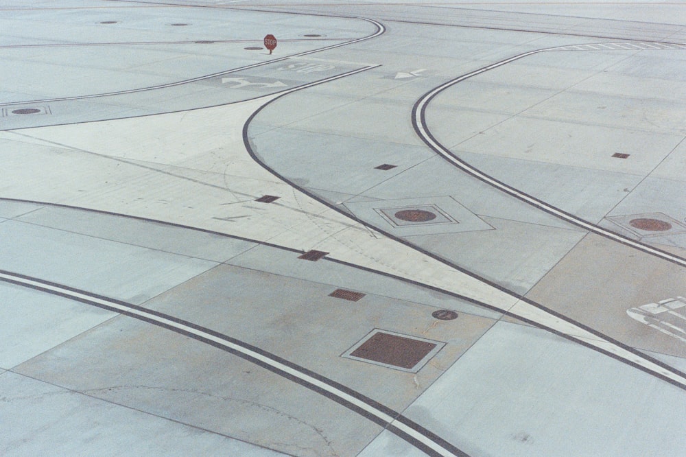 an aerial view of an airport runway with a person standing on the runway