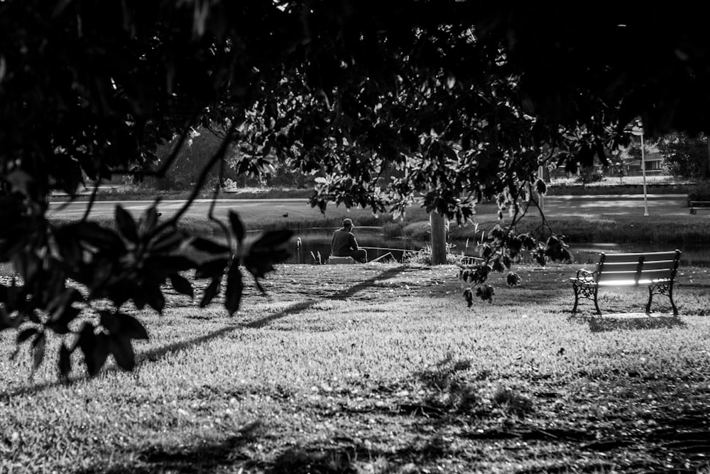 a black and white photo of a park bench