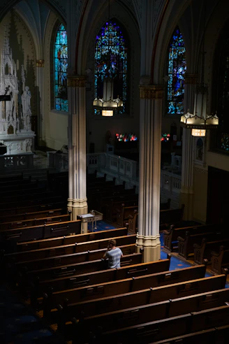 a church with pews and stained glass windows