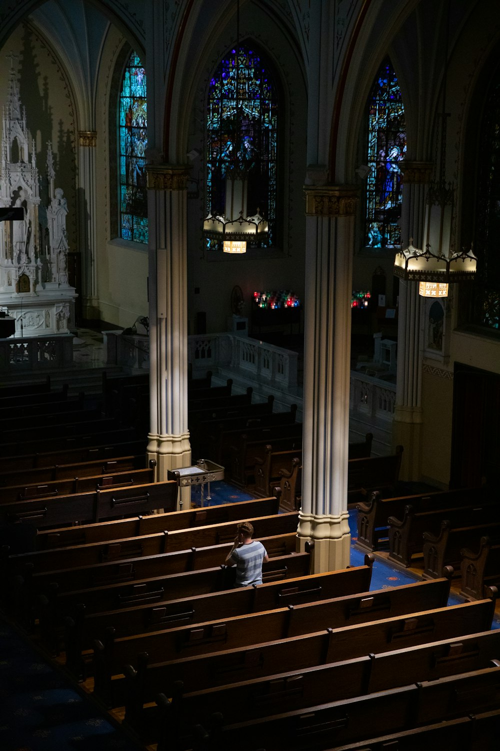 a church with pews and stained glass windows