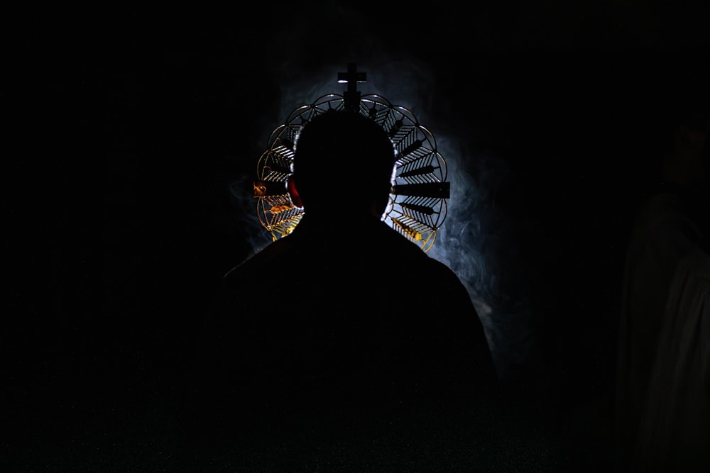 a man standing in front of a dark tunnel