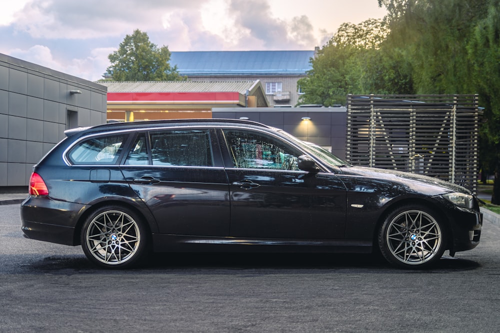 a black car parked in front of a building