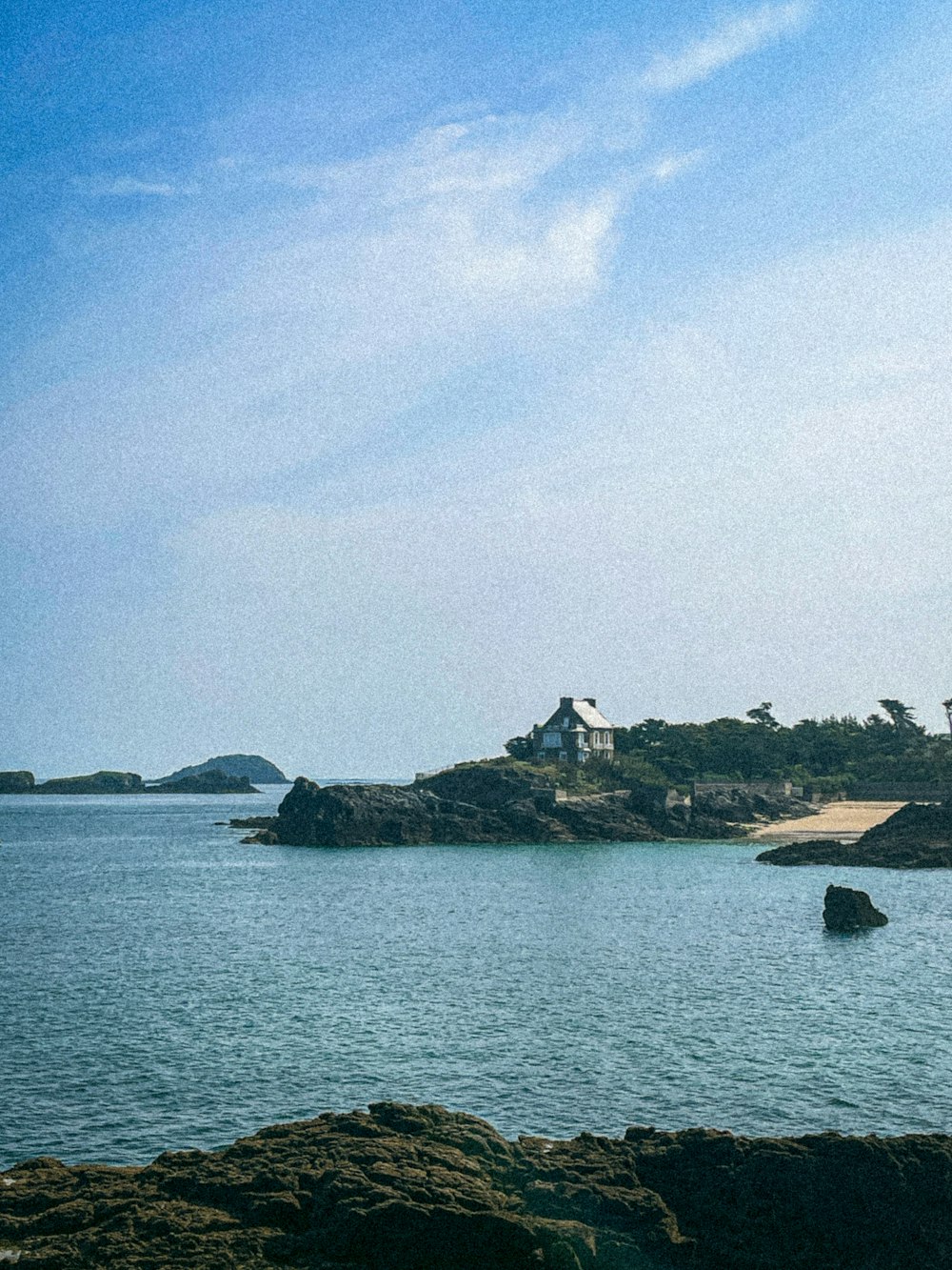 a lighthouse on an island in the middle of the ocean