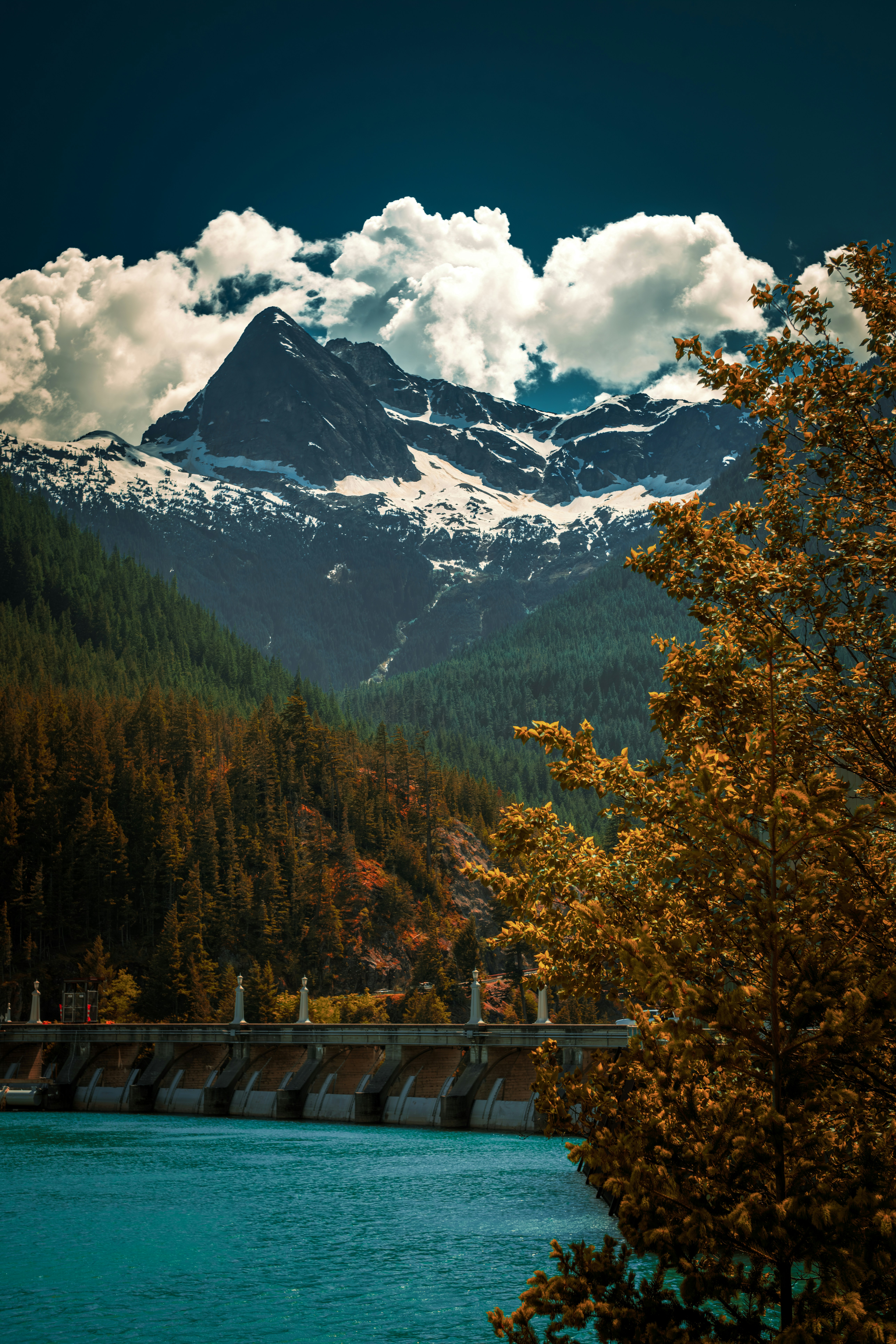 a view of a mountain range with a bridge in the foreground