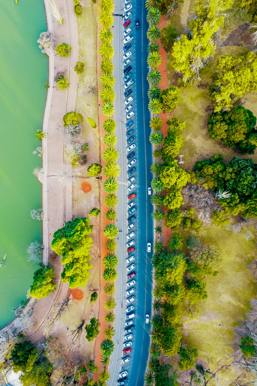 an aerial view of a road and a body of water