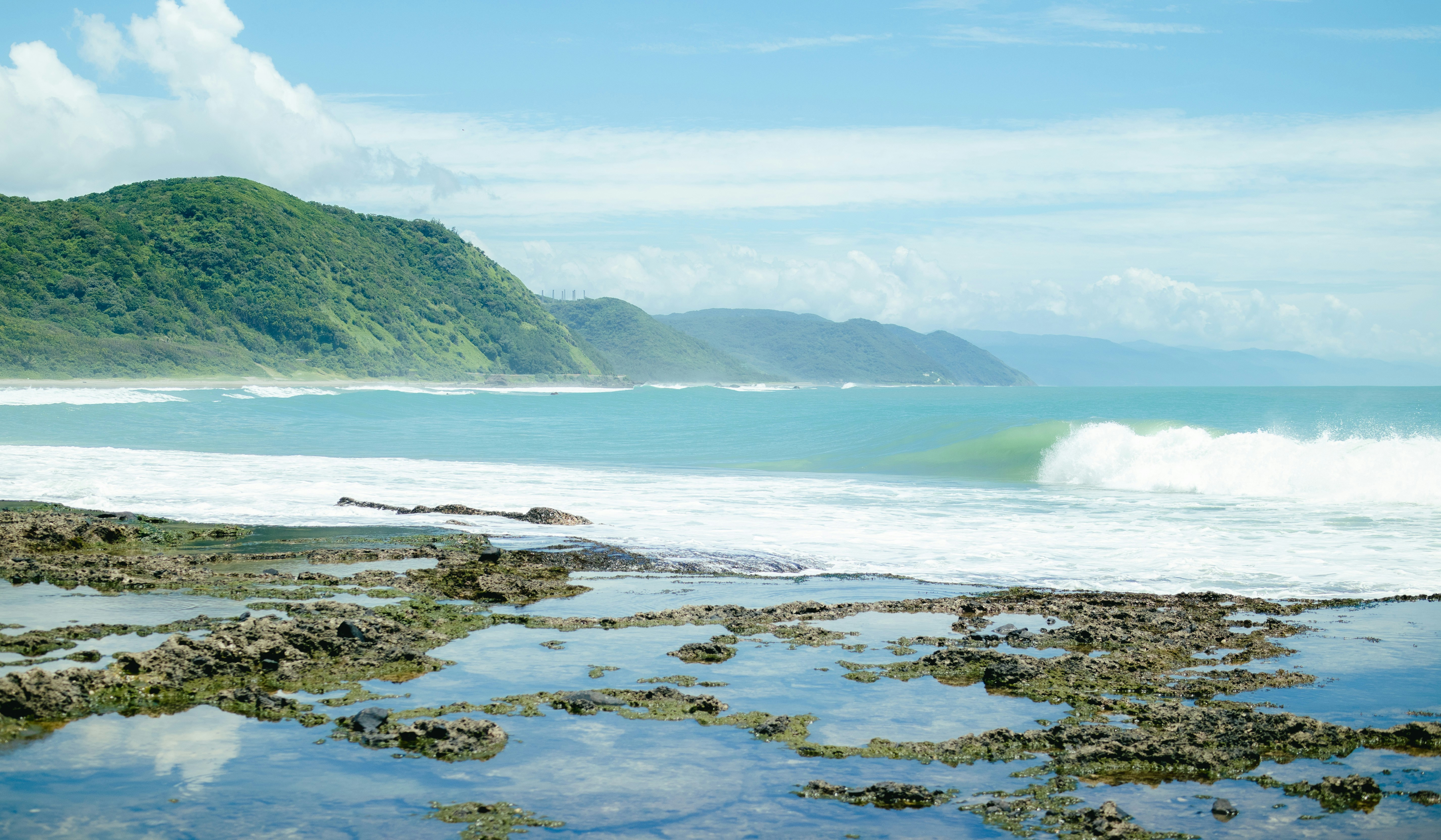 a large body of water with a wave coming in