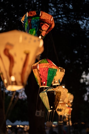 Close-up of colorful Korean festival lanterns glowing warmly at dusk.