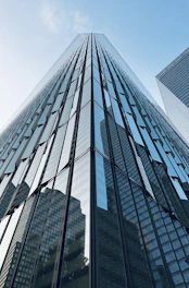 Modern business skyscraper reflecting the sky, emphasizing professionalism.