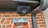 Image of a professionally mounted outdoor TV with a soundbar under a covered patio.