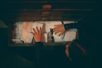An accountant carefully reviewing and organizing financial records at a desk.
