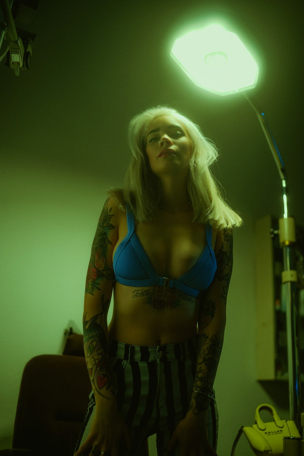 a woman with tattoos standing in a room