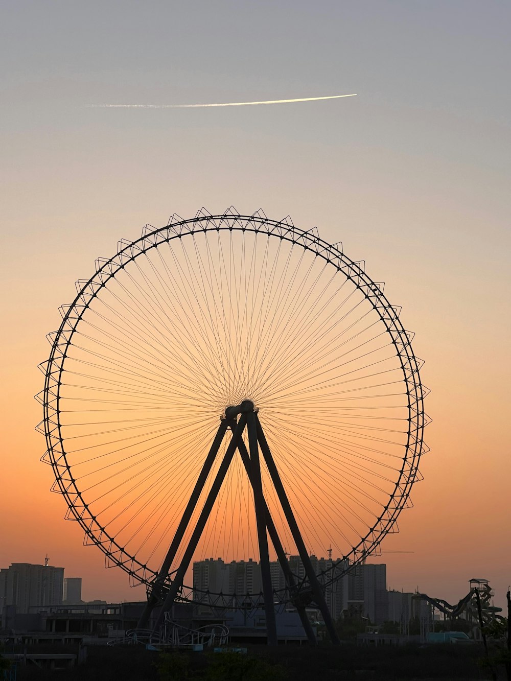 a large ferris wheel sitting in the middle of a field