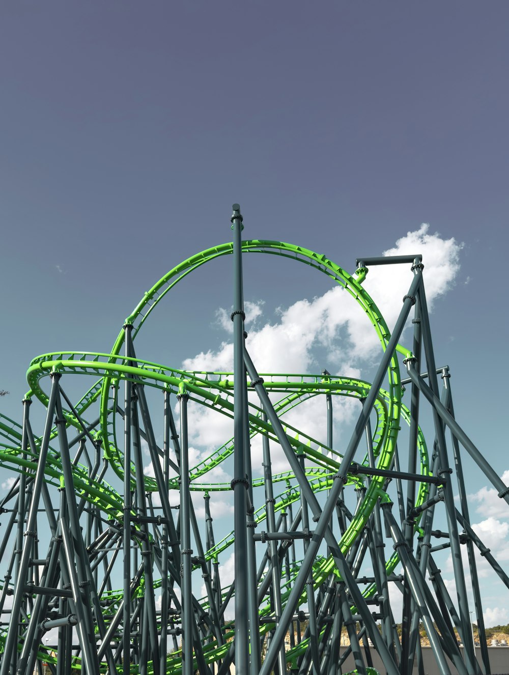 a green roller coaster going down a hill