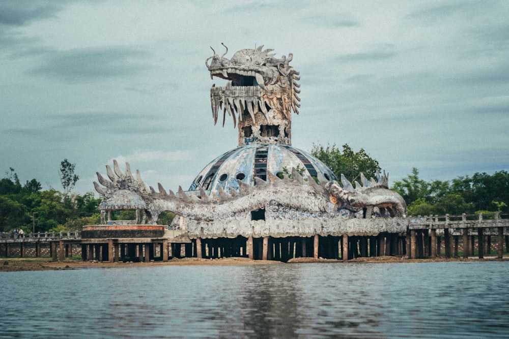 a large dragon statue sitting on top of a body of water