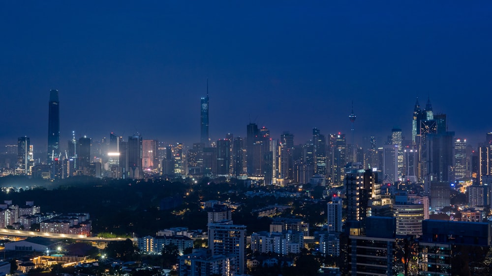 a view of a city at night from the top of a hill