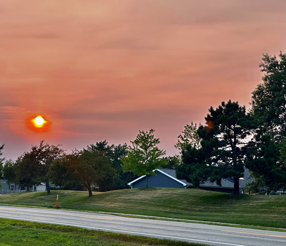 the sun is setting over a residential area