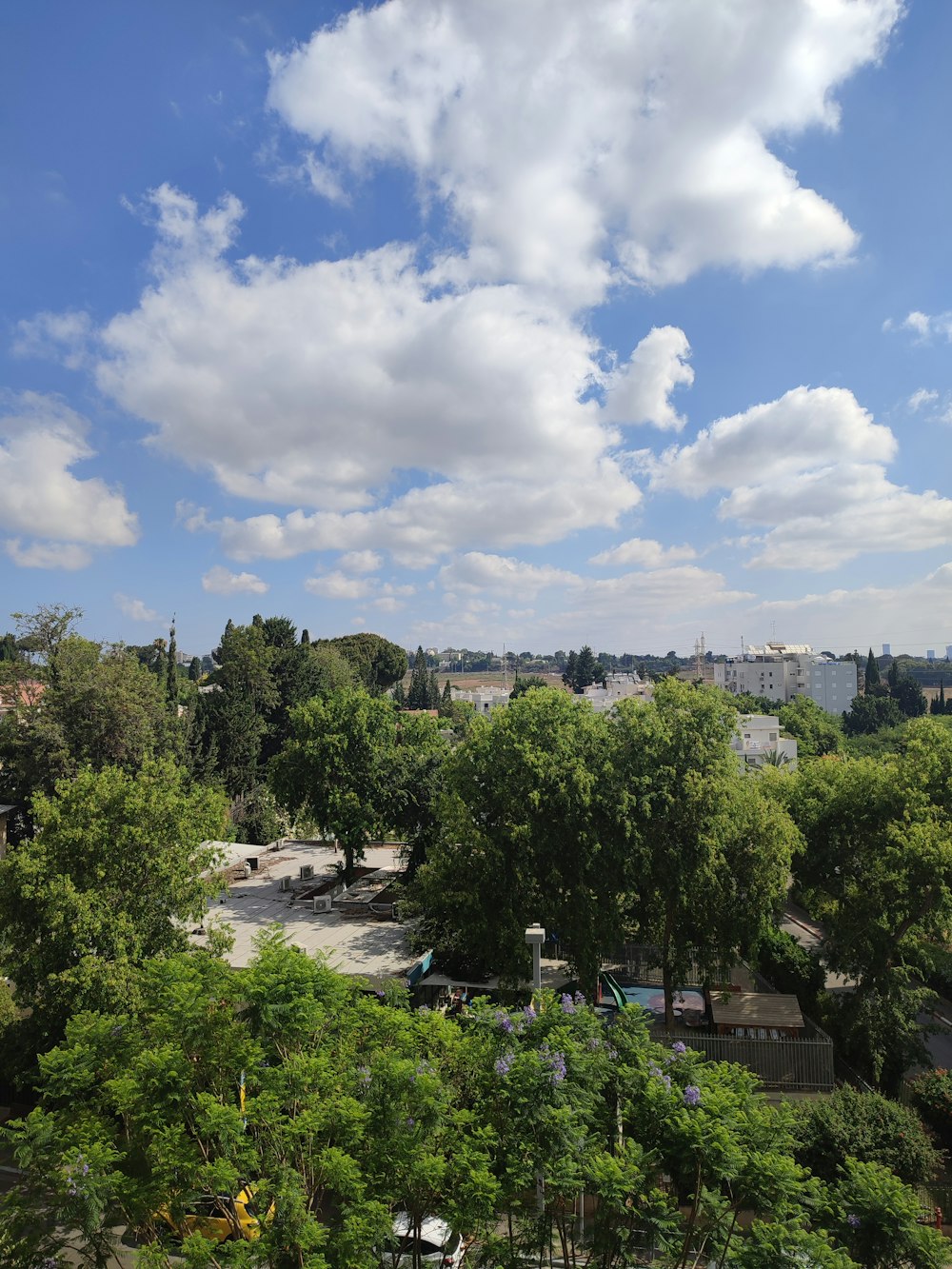 a view of a parking lot and trees