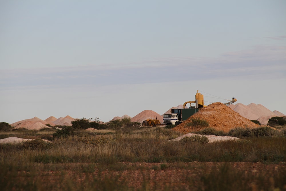 a large pile of dirt sitting in the middle of a field