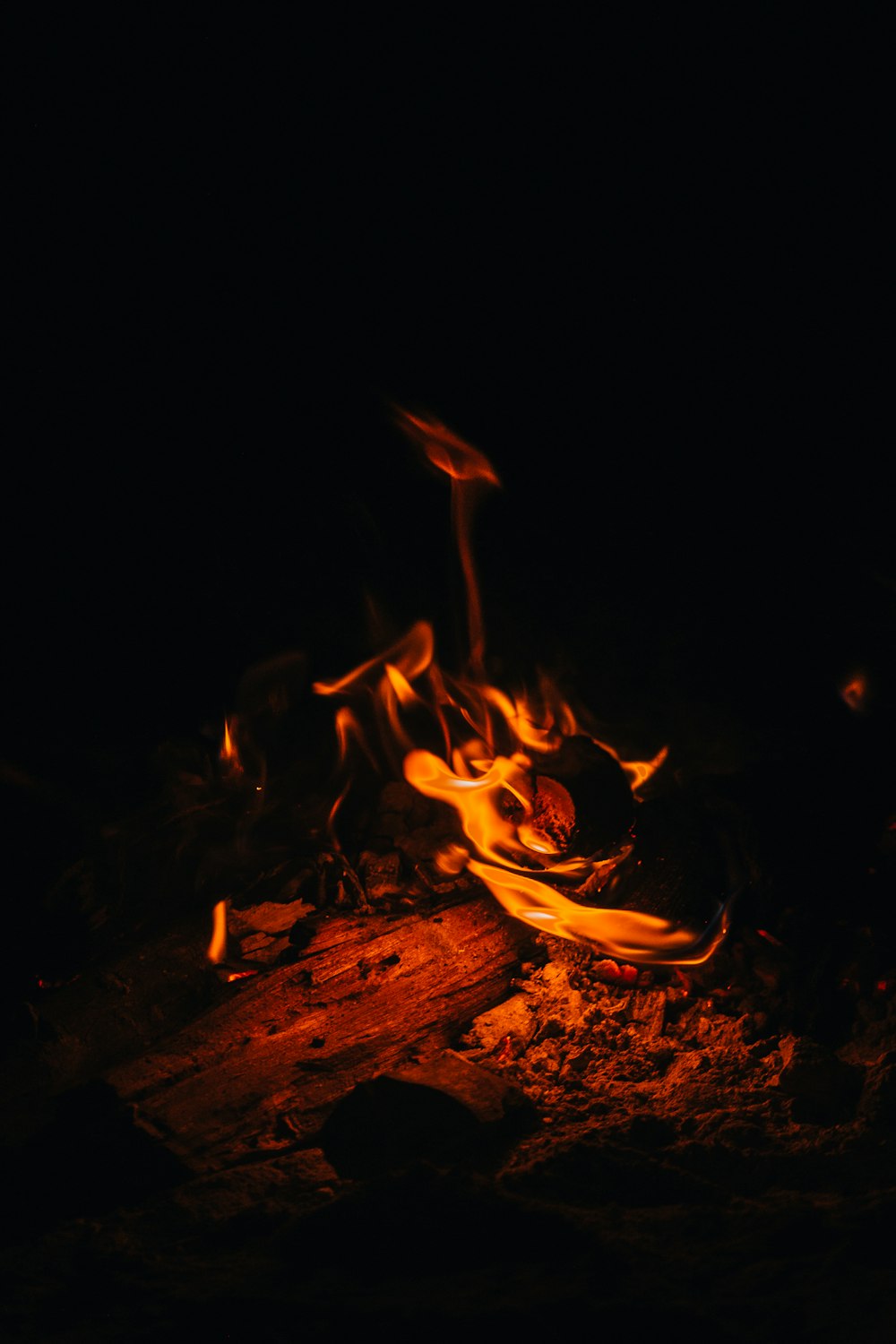 a bowl of food on fire in the dark