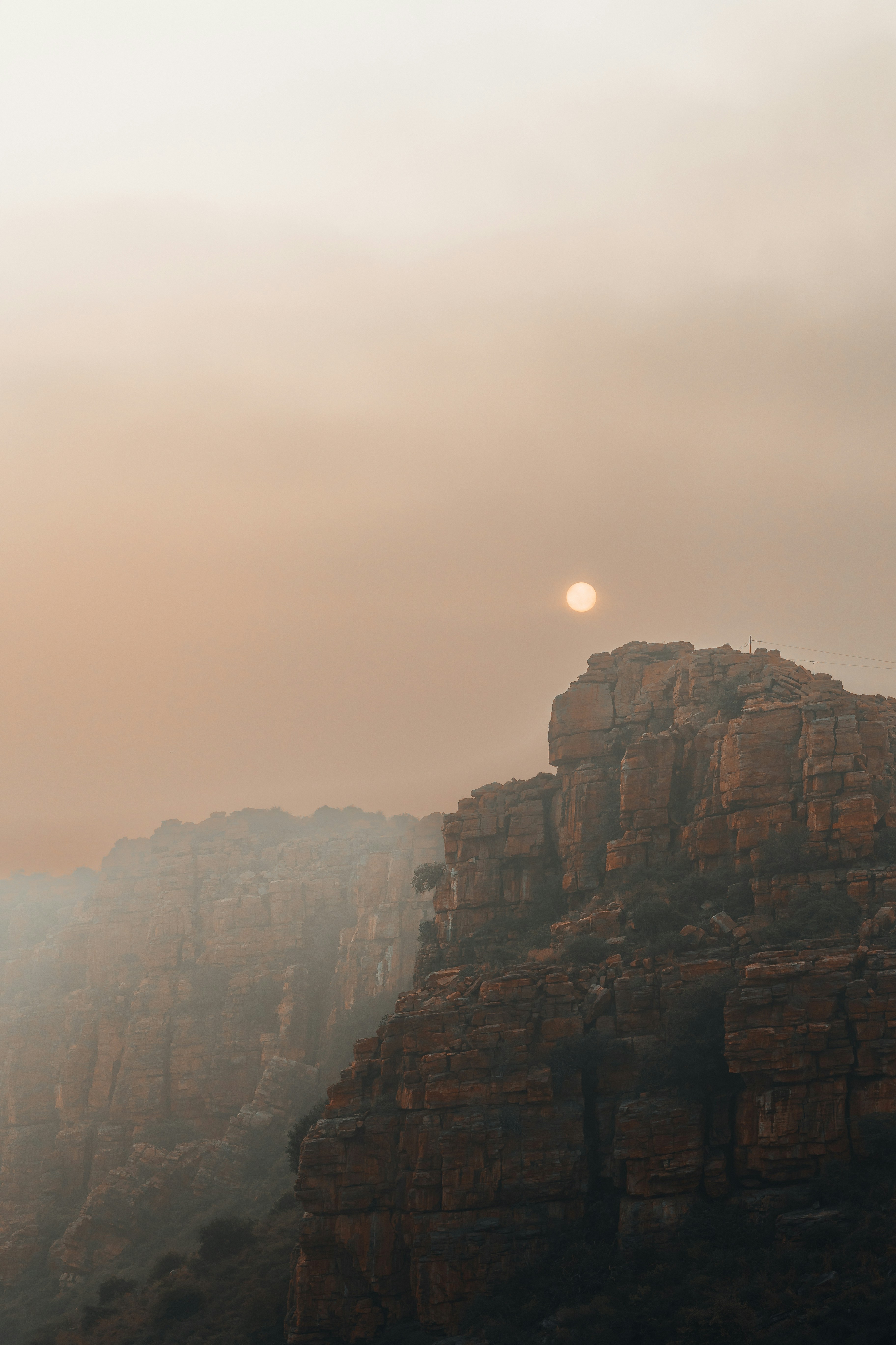 the sun is setting over the rocky mountains