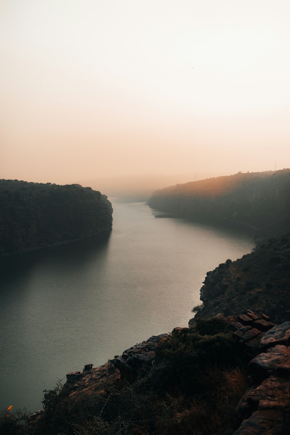 a body of water surrounded by mountains and trees