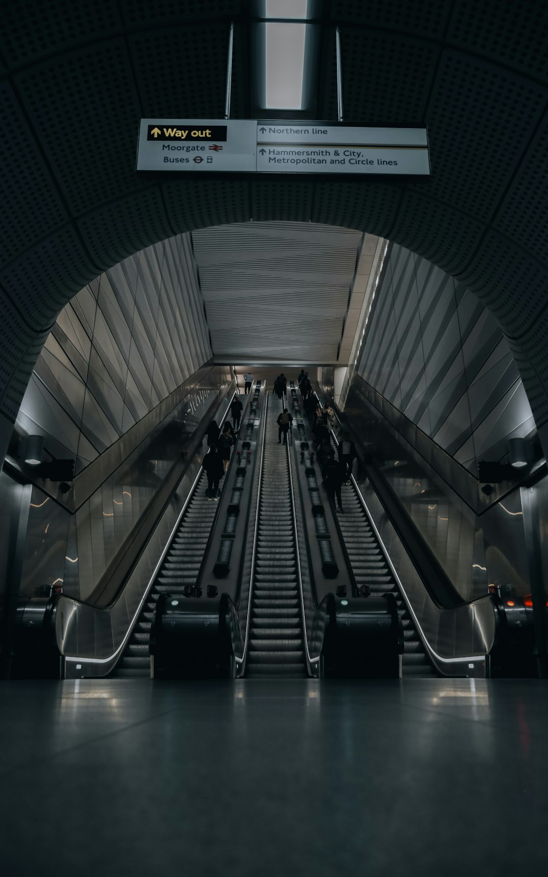 an escalator in a train station with people on it