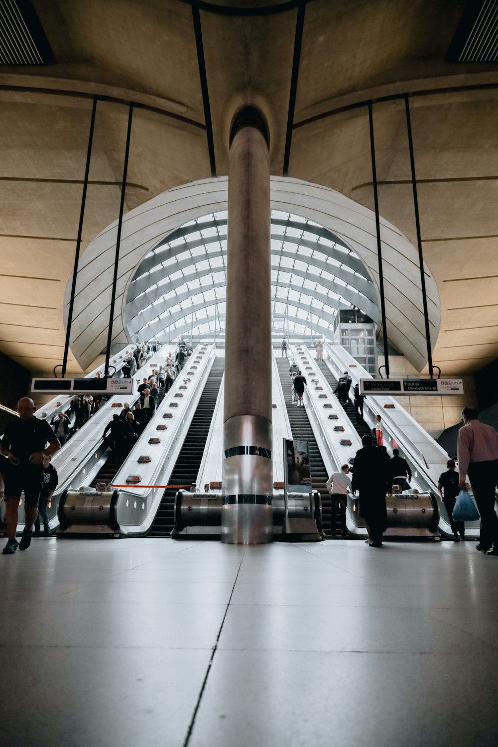 a group of people riding down an escalator