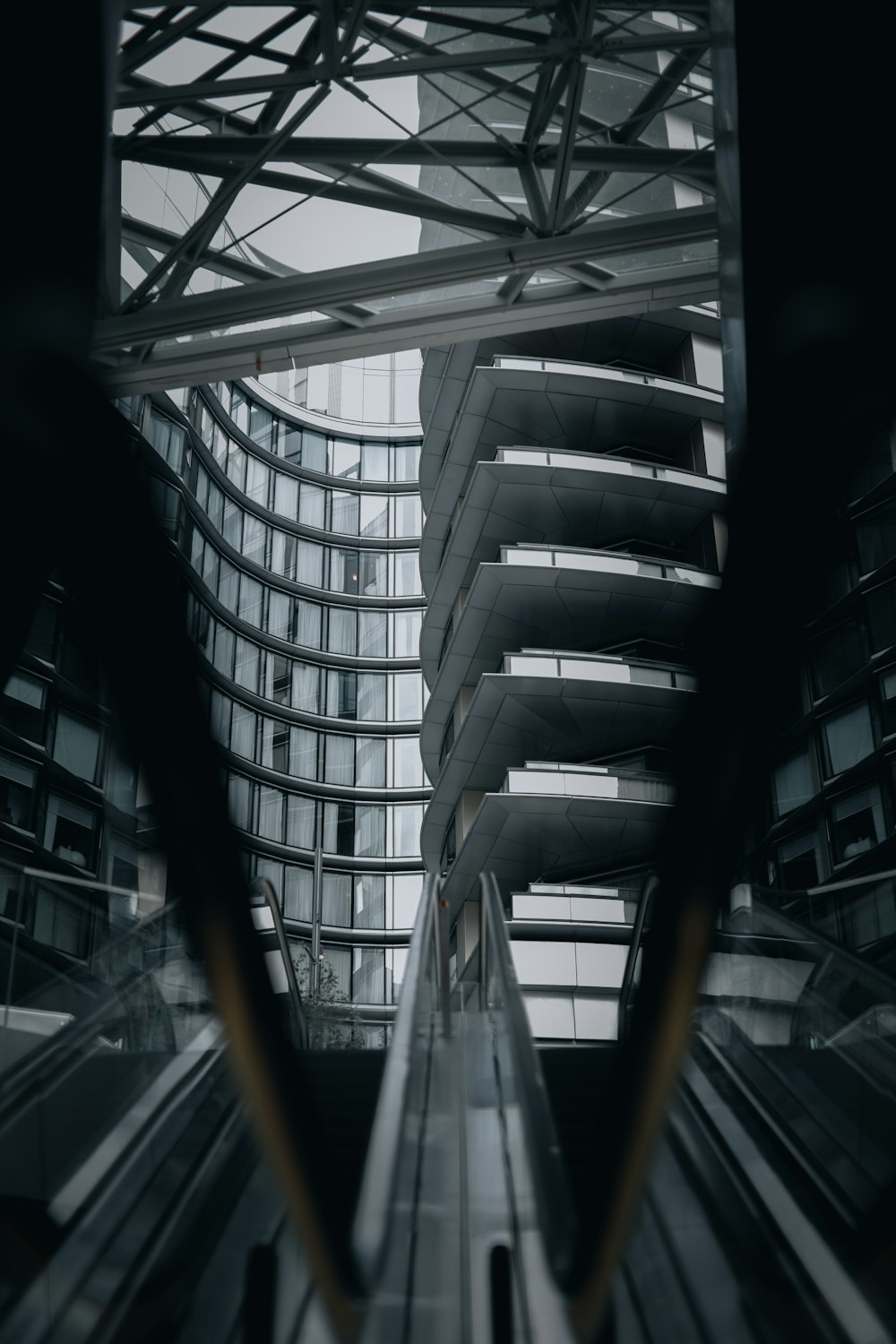 an escalator in a building with a sky background