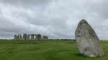 a large rock in the middle of a field