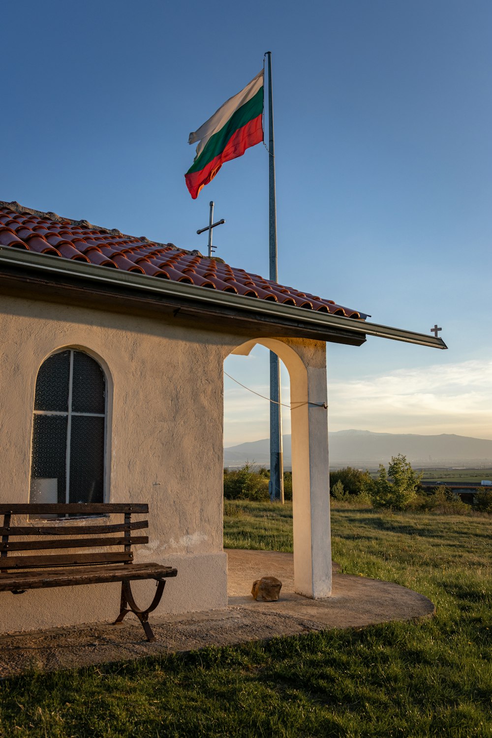 a small building with a flag on top of it