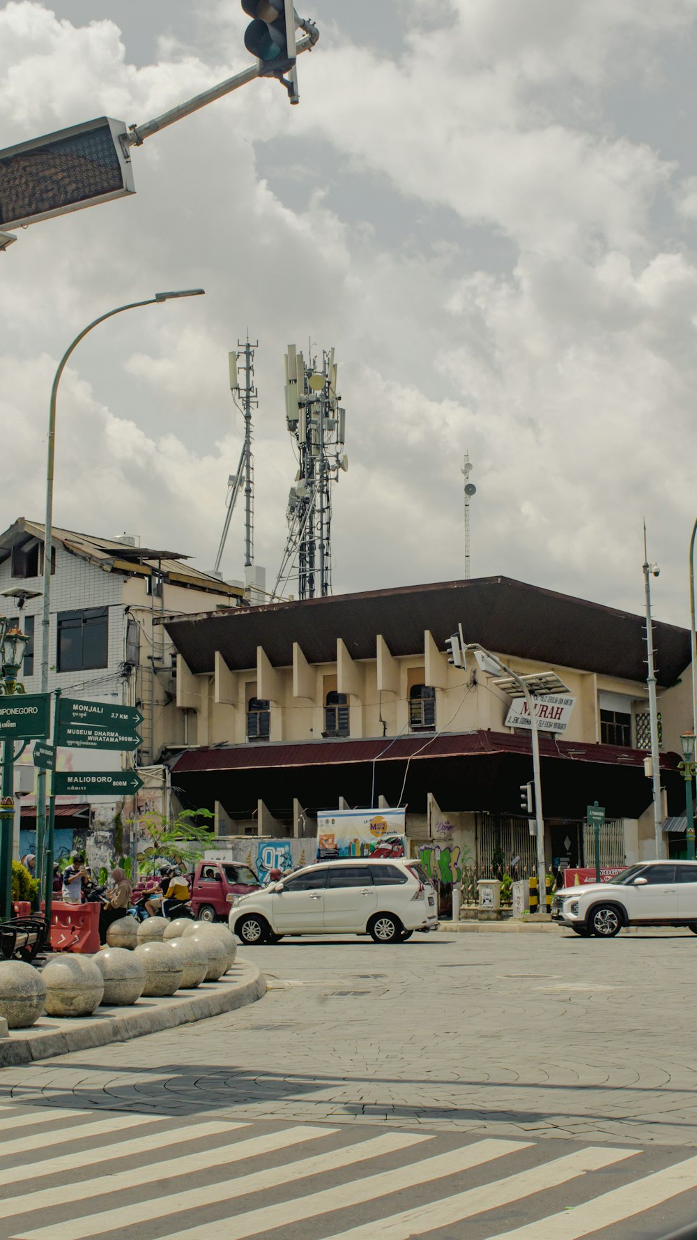 a traffic light sitting above a street next to a tall building